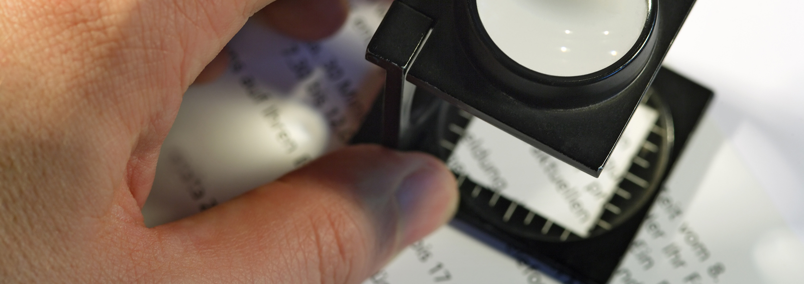 Shallow depth of field image of a printer using a loupe to check text